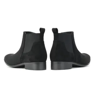 Rear view of classic black men's Chelsea boots featuring elastic side panels and low heels.