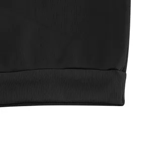 Detail view of black sweatshirt ribbed hem showcasing high-quality fabric texture.
