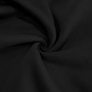 Close-up macro detail of premium black cotton sweatshirt fabric showing weave texture