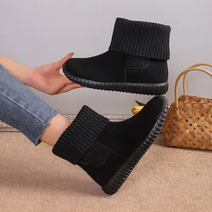 Detailed view of black winter snow boots featuring a knitted cuff and flat anti-slip soles.