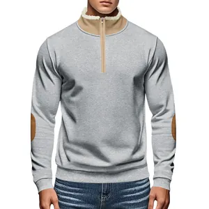 Front detail of men's grey half-zip sweatshirt with tan elbow patches and collar