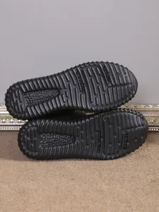 Detailed view of non-slip rubber soles for women's black snow boots with textured grip