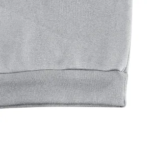 Close-up view of a grey sweatshirt ribbed hem showing high-quality fabric texture.