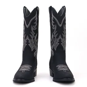 Detailed view of intricate white embroidery on black vintage men's western cowboy boots.