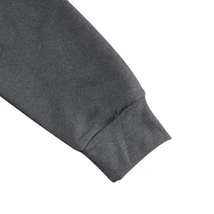 Detailed macro view of charcoal gray sweatshirt ribbed cuff and fabric texture.