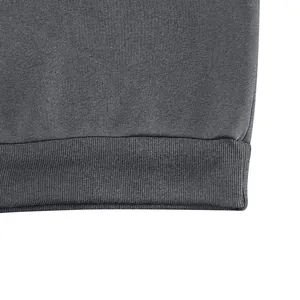 Close-up macro detail showing the ribbed hem and soft fabric texture of a vintage grey sweatshirt