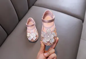 Close-up of sparkling pink rhinestone flower girl shoes for dance and performance