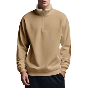 Detail of men's vintage half-zip sweatshirt with elbow patches and fleece collar