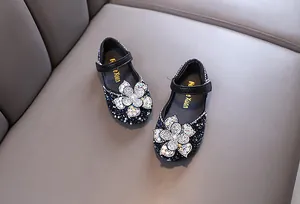 Elegant sparkly navy blue girls' Mary Jane shoes with large rhinestone flower detail