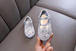 Detailed view of sparkling silver rhinestone princess shoes with a flower for girls