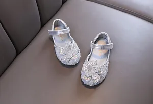 Detailed view of silver sparkly rhinestone flower shoes for girls' performance
