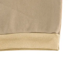 Detailed close-up showing the ribbed hem and fabric texture of a khaki retro sweatshirt