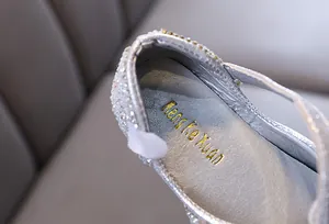 Detailed macro shot of silver glitter girl's princess dance shoe insole texture