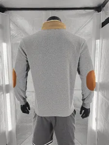 Back view of men's vintage grey sweatshirt featuring brown elbow patches and fleece collar.