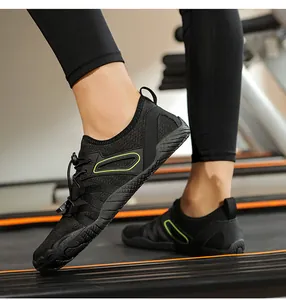 Close-up of black minimalist barefoot fitness shoes being worn on a professional gym treadmill
