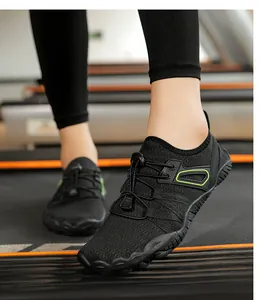 Close-up view of black breathable water shoes for indoor fitness and yoga on a treadmill