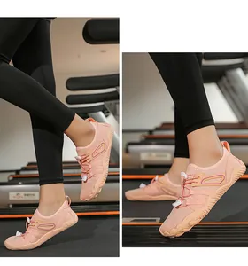 Detail shot of pink quick-dry fitness shoes worn during a gym workout.