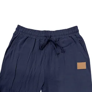 Close-up detail of men's navy blue linen pants featuring an elastic drawstring waistband