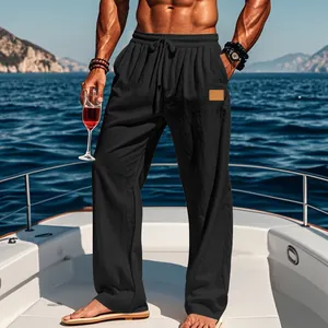 Men's black cotton linen drawstring pants shown in a luxury yacht vacation setting
