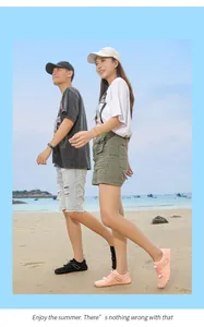 Couple walking on a sunny beach wearing breathable outdoor water shoes for swimming