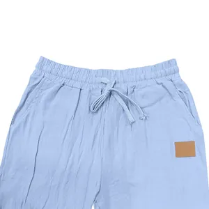 Close-up detail of light blue breathable men's linen shorts featuring a drawstring waist design
