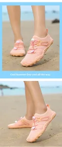 Peach-colored quick-dry water shoes worn on a sandy beach for summer activities