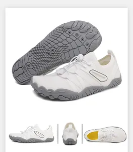 Macro detail view of white outdoor wading shoes featuring grey non-slip rubber soles