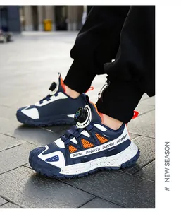 Kids' navy and white sports sneakers with rotary lace system for outdoor activities.
