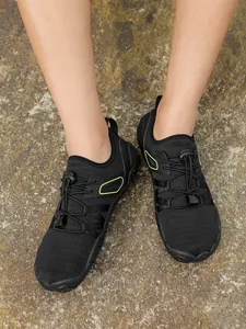 Lightweight black barefoot water shoes for swimming and hiking on stone ground.