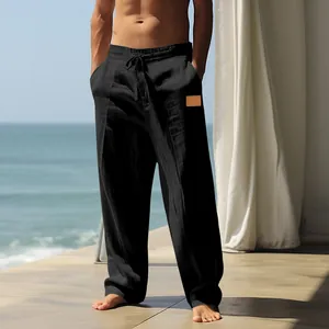 Close-up detail of men's loose black linen drawstring pants for breathable beach wear