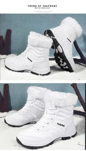 Detailed view of white winter snow boots featuring warm faux fur lining and anti-slip rubber soles