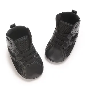Close-up of black breathable mesh baby sneakers with soft soles for toddlers
