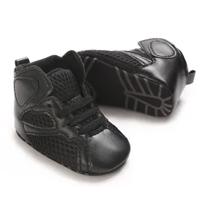 Detail of black infant high-top walking shoes with breathable mesh and soft sole.