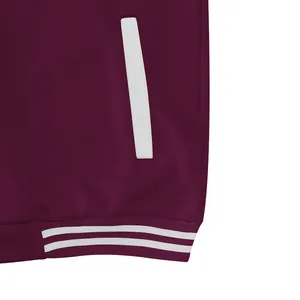 Detail van bordeauxrood varsityjack met witte zak en gestreepte geribbelde zoom