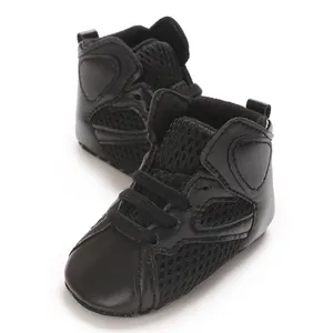Detailed view of black infant high-top walking shoes featuring breathable mesh texture