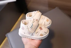 Macro view of warm toddler snow boots featuring cute bear patterns and fuzzy lining
