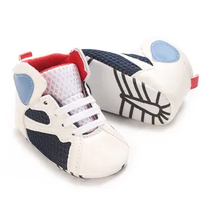 Detail view of soft-sole baby walking shoes with breathable navy mesh and white leather.