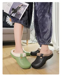 Detail view of lined winter plush slippers for couples shown in a cozy home setting