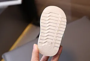 Close-up macro view of the anti-slip rubber outsole on warm baby winter snow boots