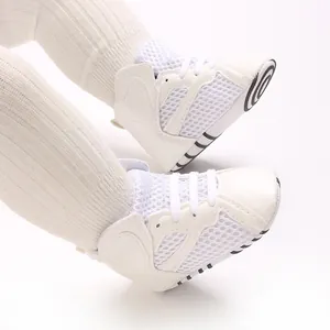 Detailed macro view of white breathable mesh baby walking shoes with flexible soft soles