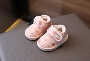 Detailed view of pink fleece-lined baby snow boots featuring cute bear patterns and velcro