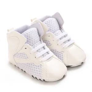 Detailed macro view of white breathable mesh and soft leather baby sneakers