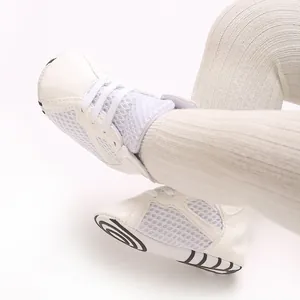 Close-up detail of breathable white mesh baby walking shoes featuring soft non-slip soles