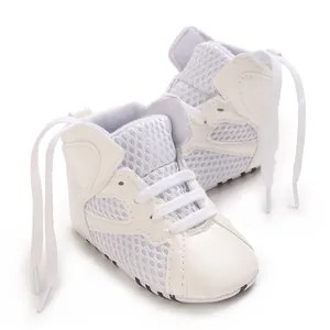 Close-up of white breathable mesh infant walking shoes with soft soles
