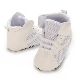 Close-up of white high-top baby walking shoes with breathable mesh and soft soles.