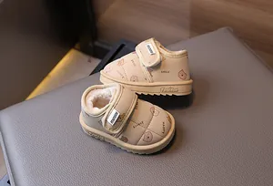 Detailed view of beige fleece-lined toddler snow boots featuring cute bear prints and velcro strap