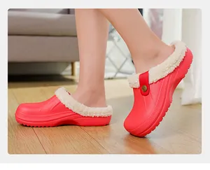 Close-up of red plush-lined winter clogs showing soft faux fur interior and round toe