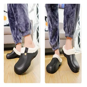 Close-up of stylish black fleece-lined clogs worn indoors for winter warmth and comfort.
