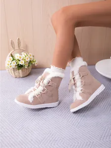 Cozy beige faux fur-lined lace-up snow boots for women featuring durable flat white soles