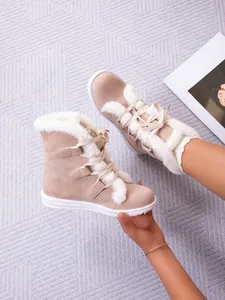 Cozy beige lace-up snow boots with white faux fur lining and flat soles